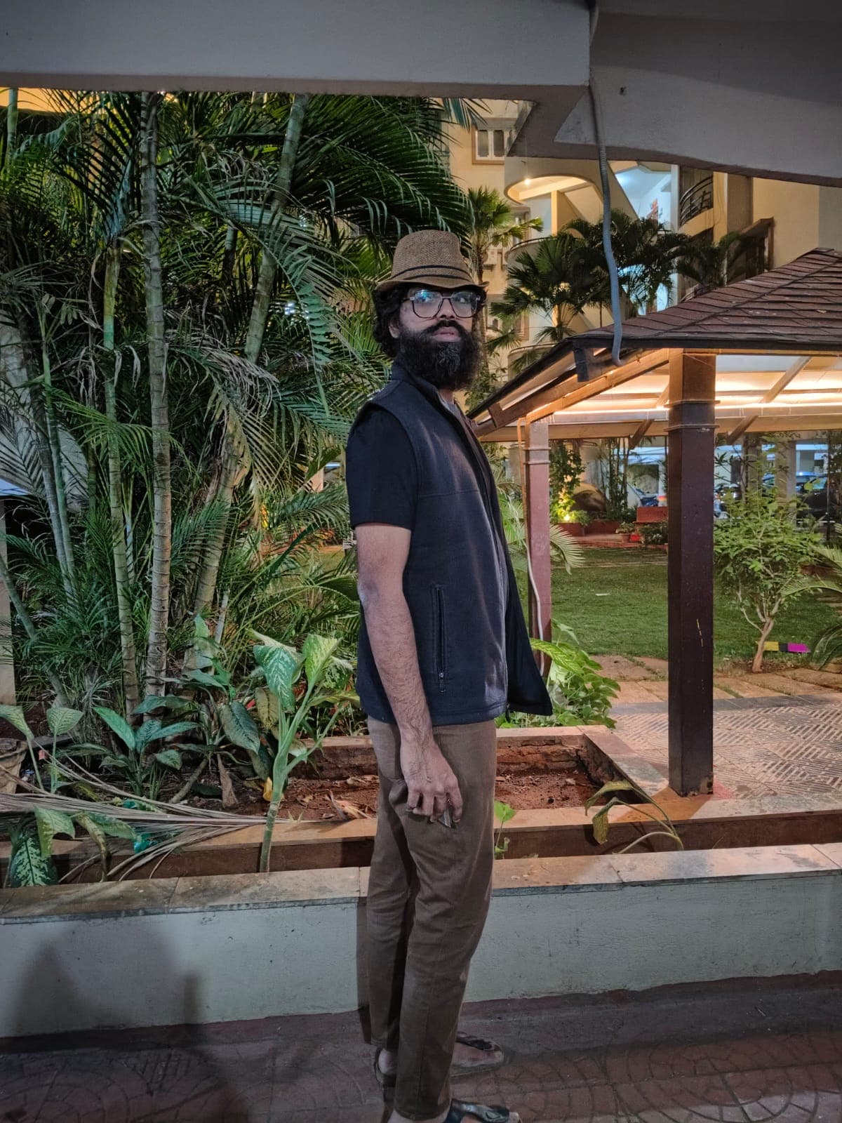 Shiv standing outdoors in a hat and glasses